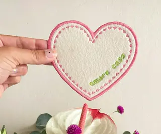 Herzförmige Filz-Serviette mit rosa Stickerei und grünem Schriftzug Amore Casa personalisierbar